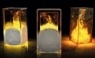 three glass boxes containing fire