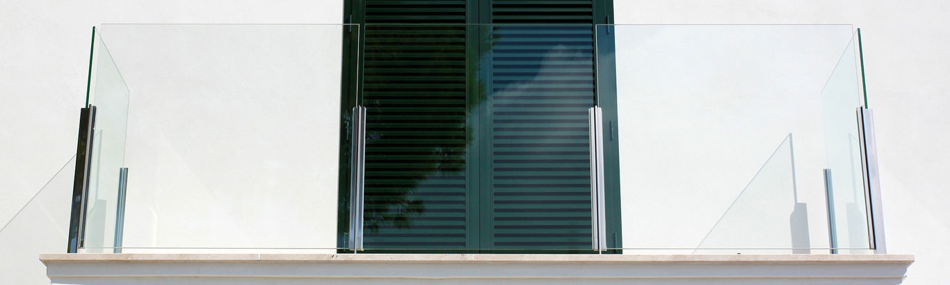photo from below a balcony showing glass balustrades installed